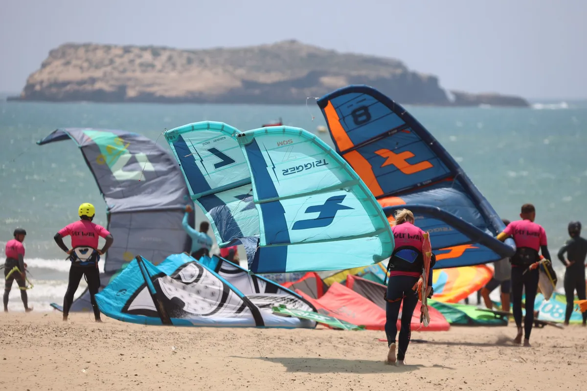 Kites on the beach facing the island